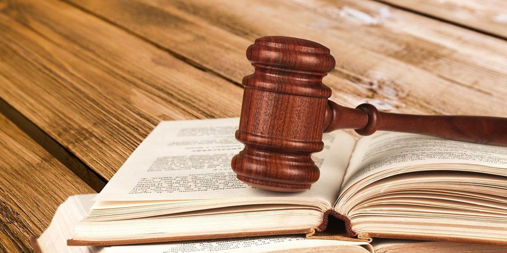 a gavel resting on a law firm book that describes social media marketing for law firms