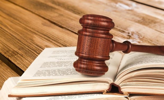 a gavel resting on a law firm book that describes social media marketing for law firms