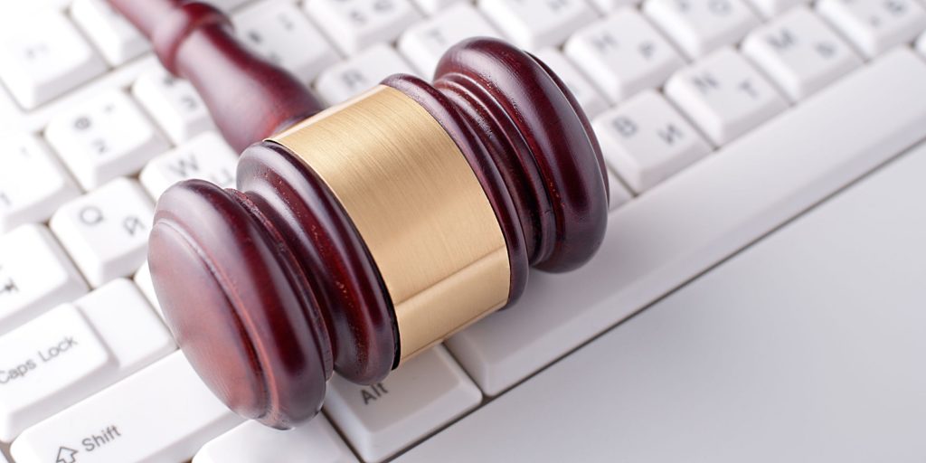 a gavel on top of a keyboard which portrays law firms using social media that is used for basic marketing