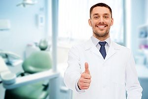 dentist holding a thumbs up after working successfully with a dental marketing agency