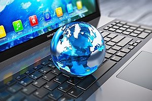 a globe on top of a computer symbolizing web marketing for dentists and how it is  important for any dental practice