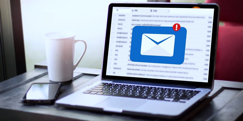 a coffee mug next to a phone and a laptop that shows an email that was received from a customer as a part of an email marketing campaign for a local business