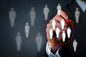 a business owner circling a few people with in a group to represent a target audience