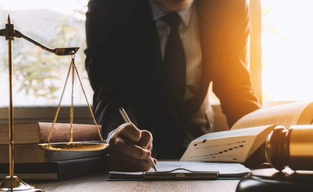 Attorney writing down law firm marketing ideas