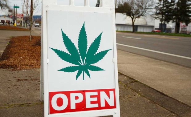 Open sign for dispensary who read how to market your dispensary in 2021