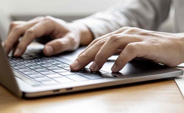 person typing meta description on computer