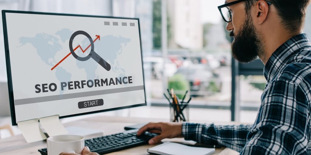 developer working with computer with performance on screen at workplace