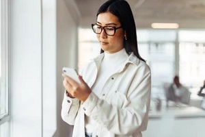 asian women checking text message on the phone