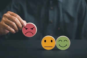 man picking up negative smiley