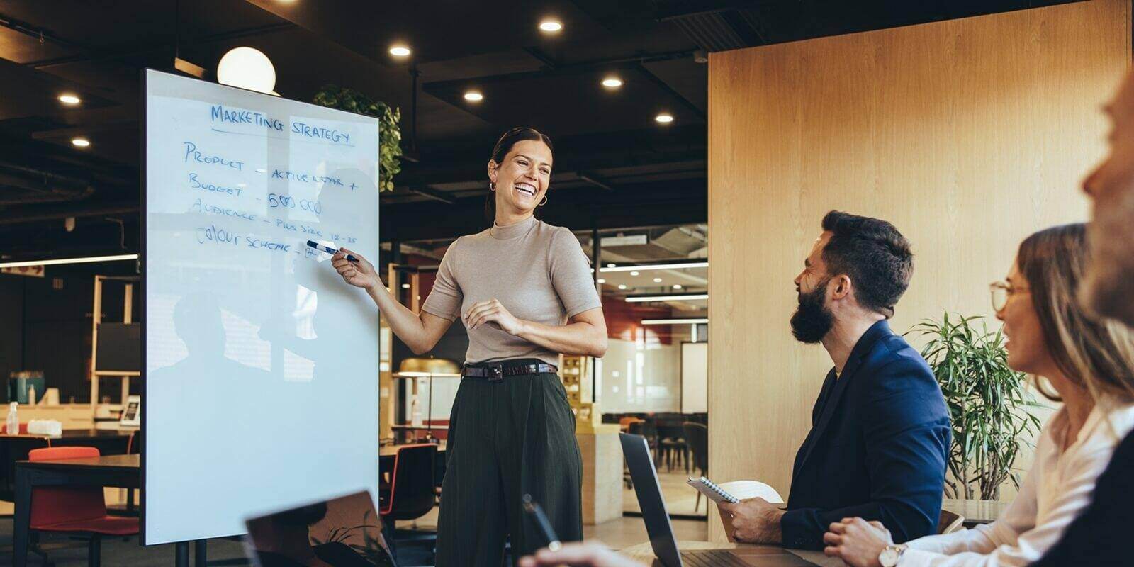 cheerful business manager giving a presentation about fractional marketing