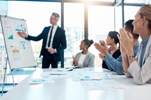  Fractional marketing presentation and applause with a business man training his team during a boardroom workshop