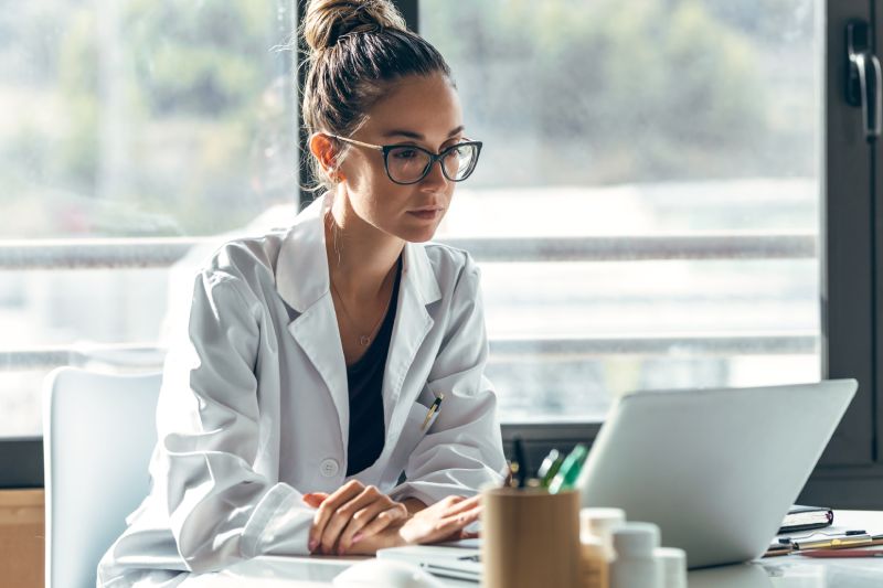 Doctor Looking At The Results Of Her Healthcare Marketing Campaign