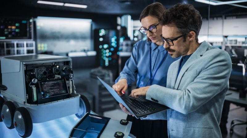 IT Professionals Looking At The Analytics Of Their IT Marketing Campaign