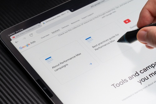 Google Ads dashboard shown on a table that advertises Pmax campaigns